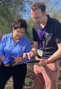 Dr. Lori Moore-Merrell of FEMA, gets an explanation of the workings of an N5 Sensor deployed to detect wildfires near Makauwahi Cave, from engineer Brian Thomson of N5 Sensors.